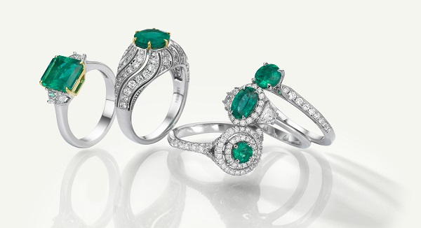 A collection of emerald and diamond rings